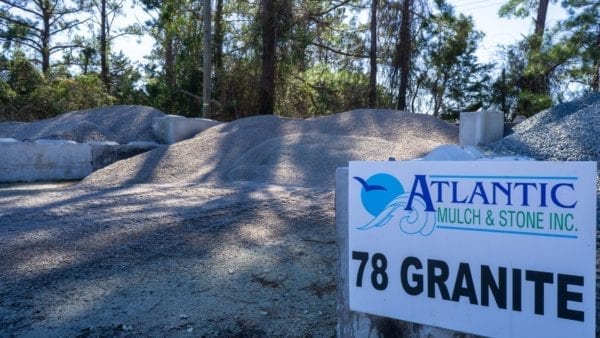 78 granite mound with Atlantic Mulch & Stone sign to the right