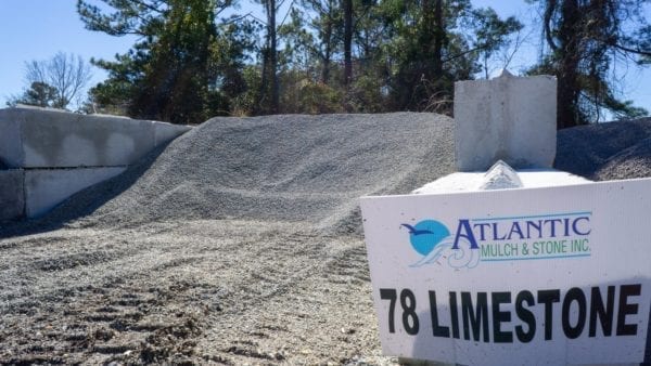 mound of 78 limestone with Atlantic Mulch & Stone sign to the right