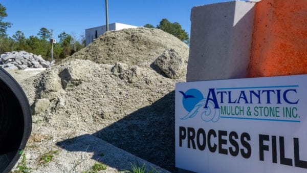 processed fill dirt with Atlantic Mulch & Stone sign to the right